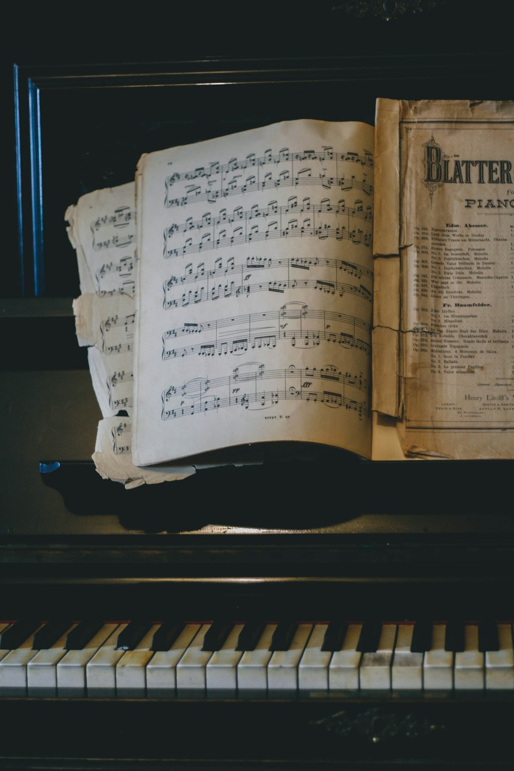 an open book sitting on top of a piano