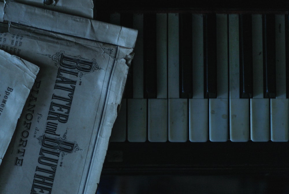 a pile of newspapers sitting next to a piano