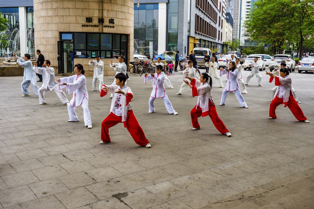 a group of people in red and white outfits dancing