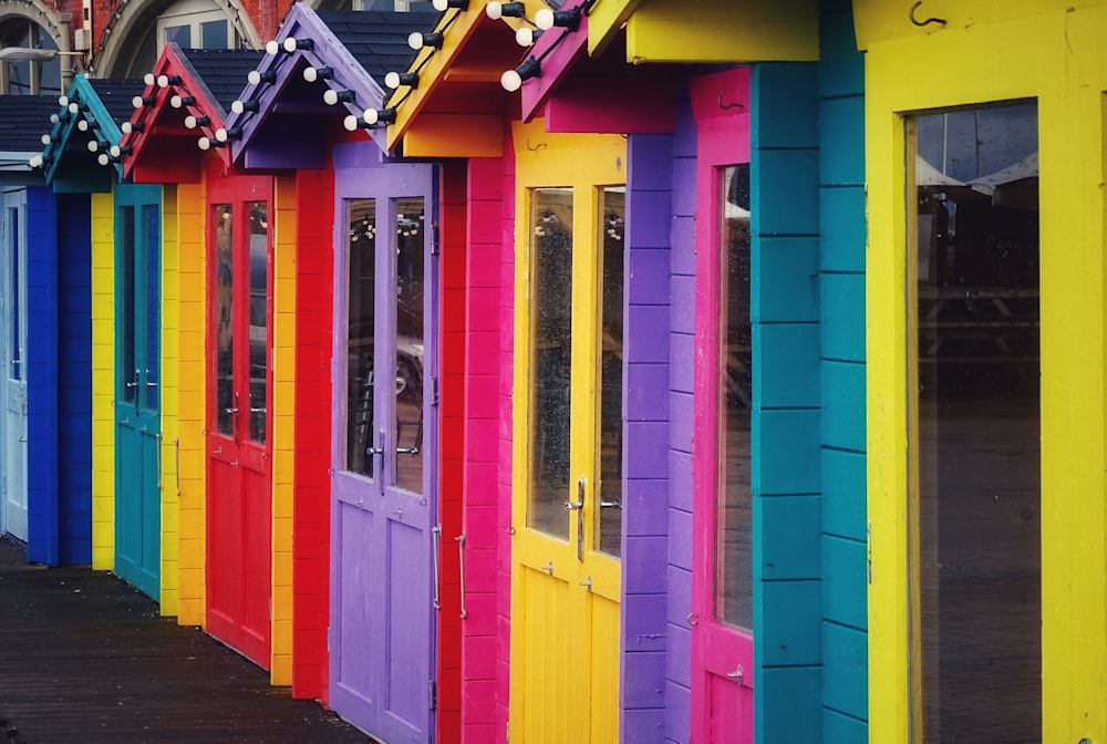 a row of brightly colored doors on a building