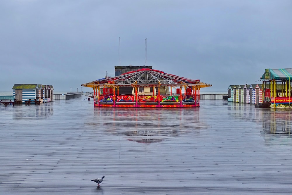 a group of colorful buildings sitting on top of a wet ground