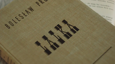 Close-up of a book cover in Polish with intricate artwork.