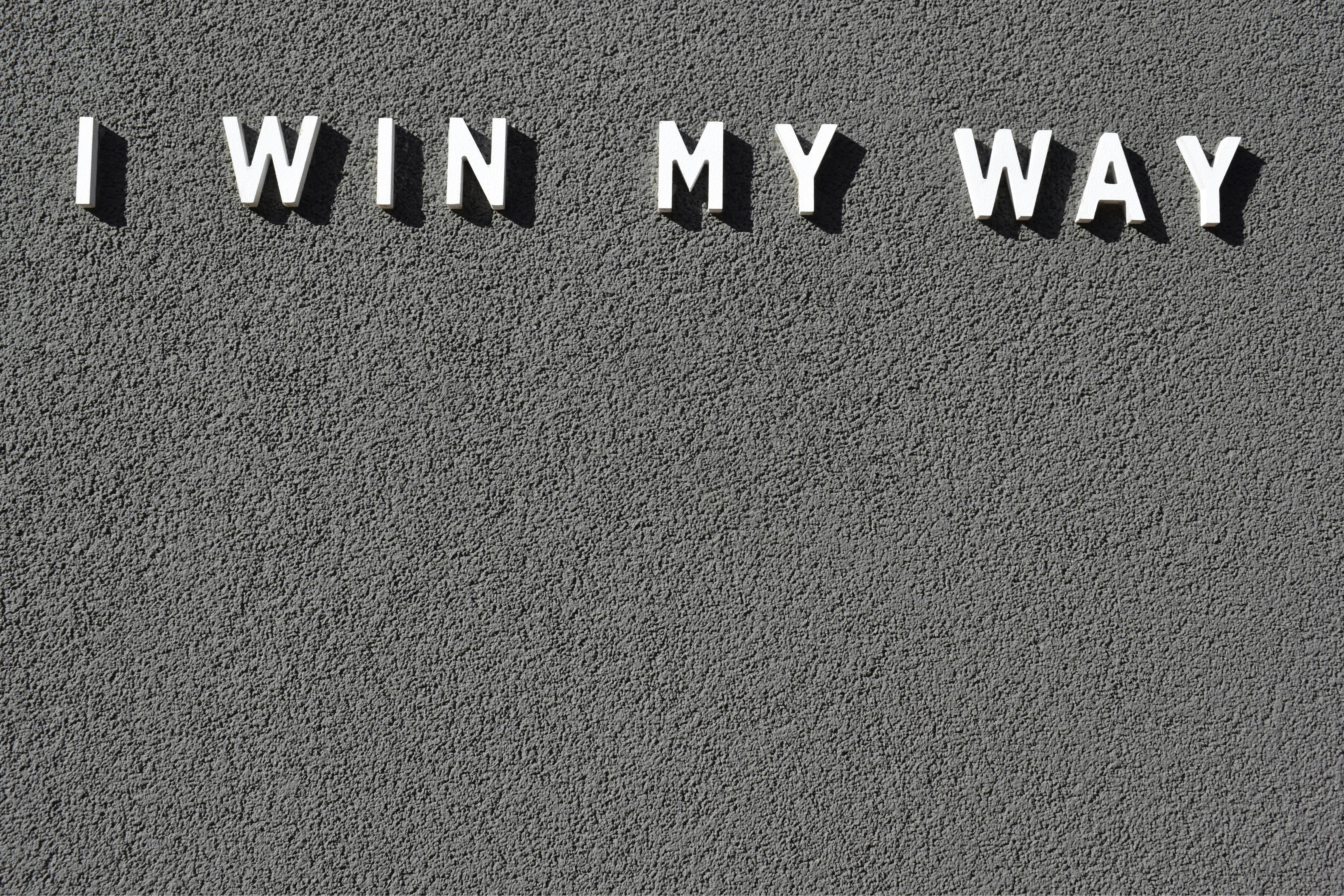 the words i win my way written on a wall