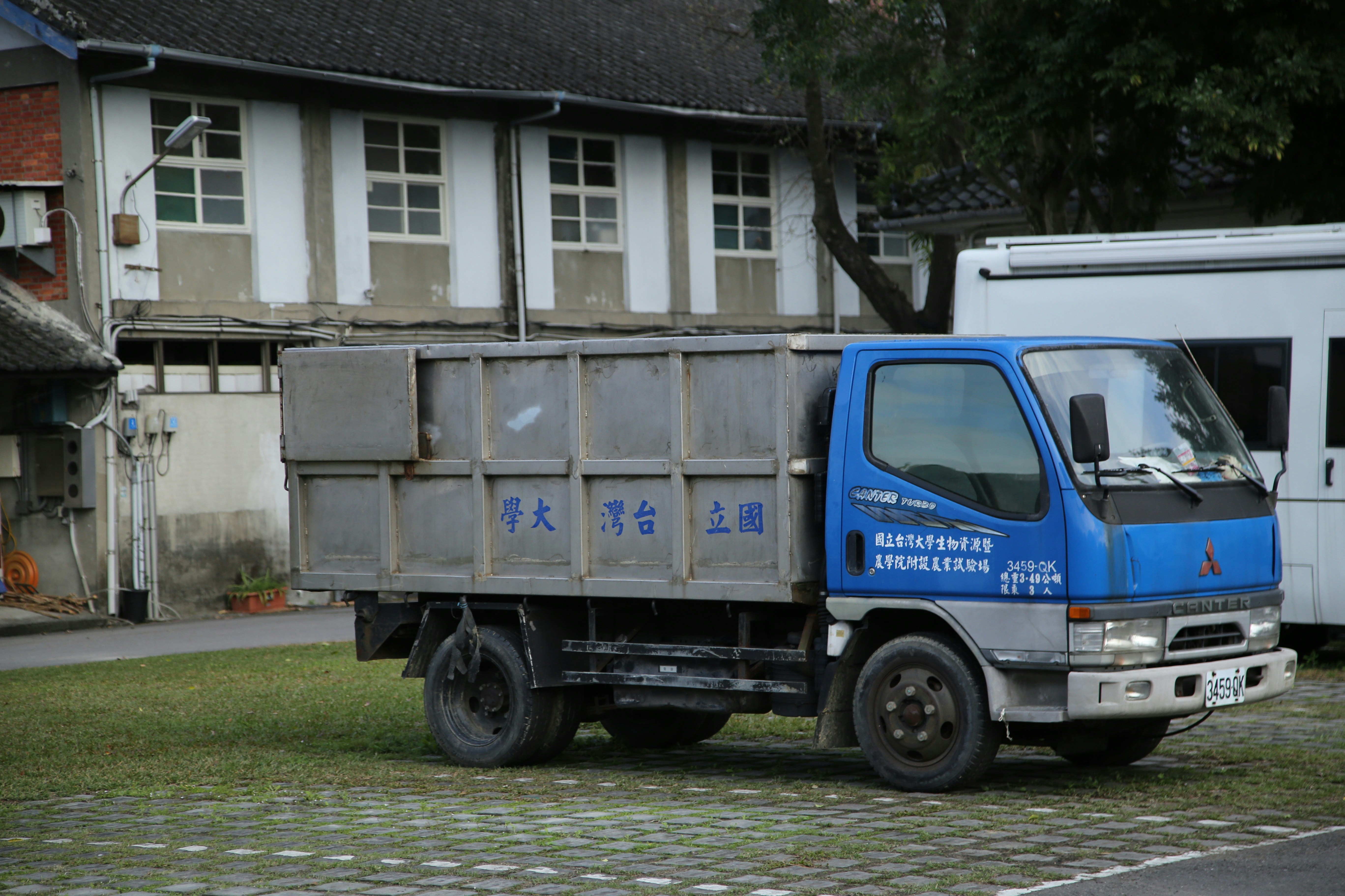 a blue truck parked in front of a building
