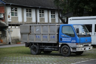 a blue truck parked in front of a building