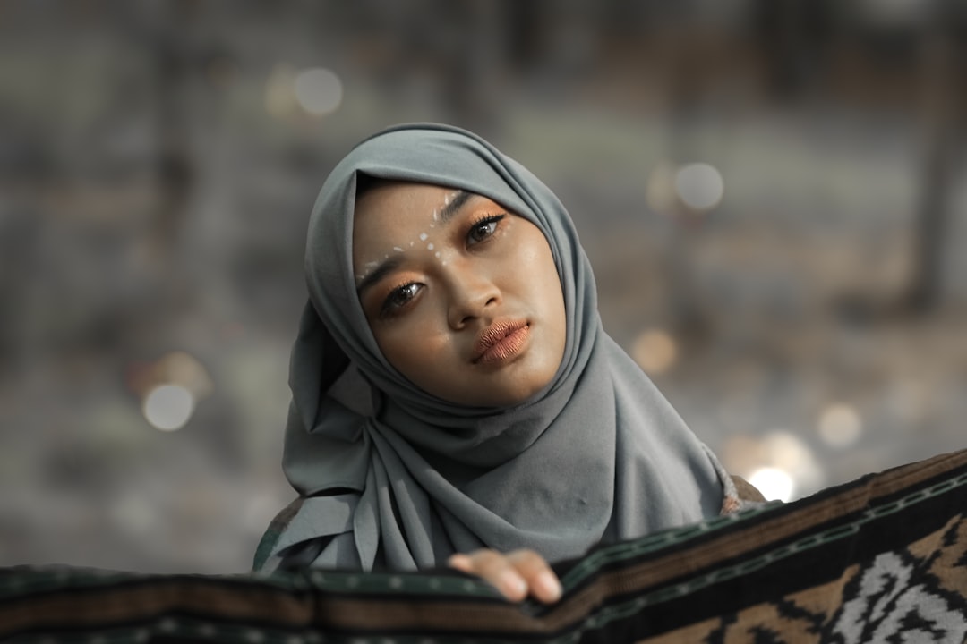 a young woman wearing a headscarf looking at the camera,