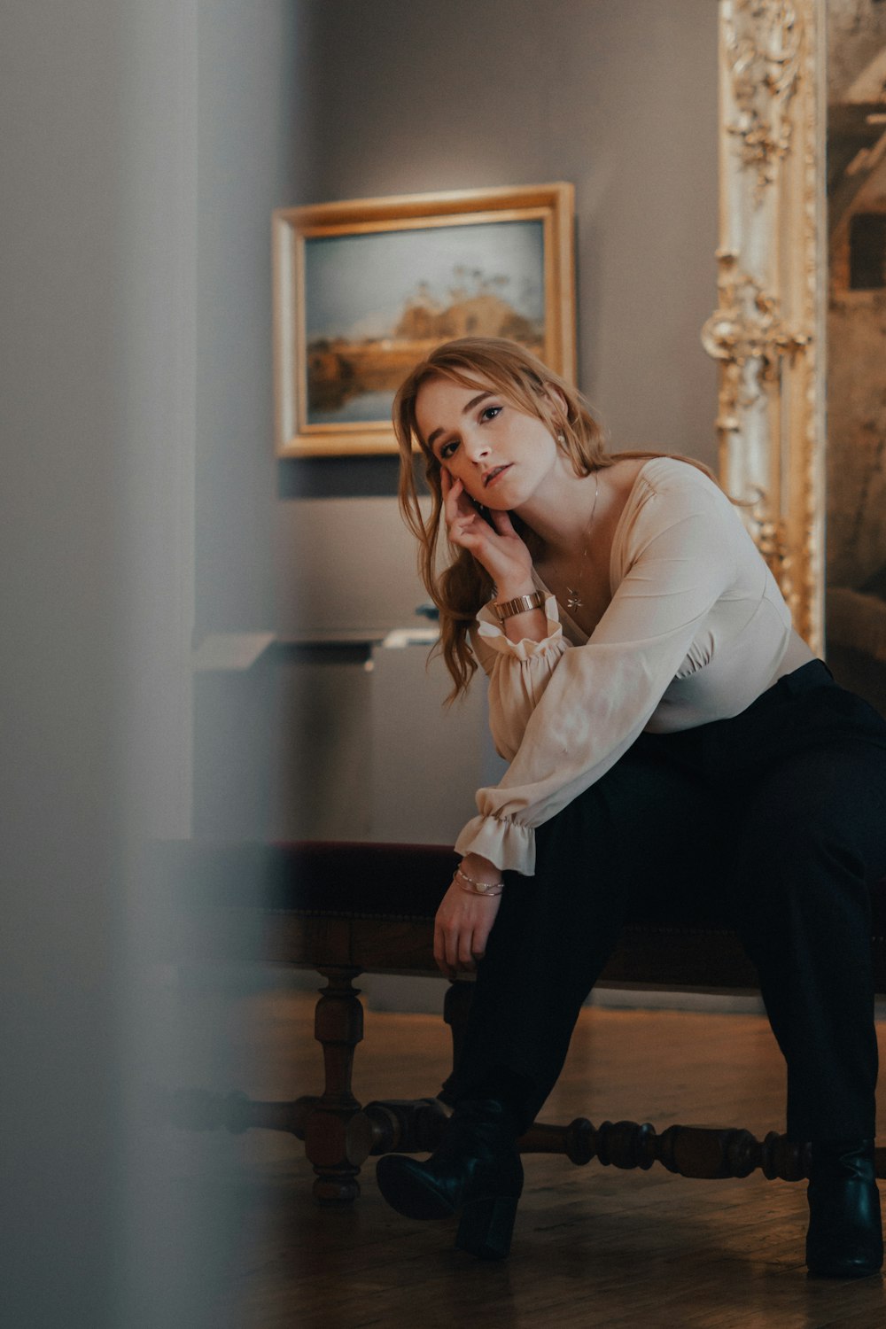 a woman sitting on a bench in a room