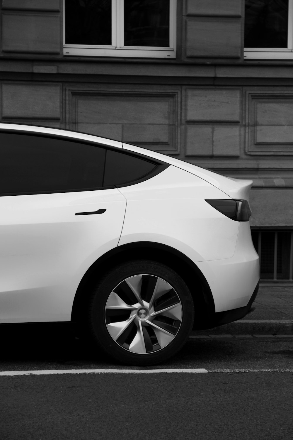 a white car parked in front of a building