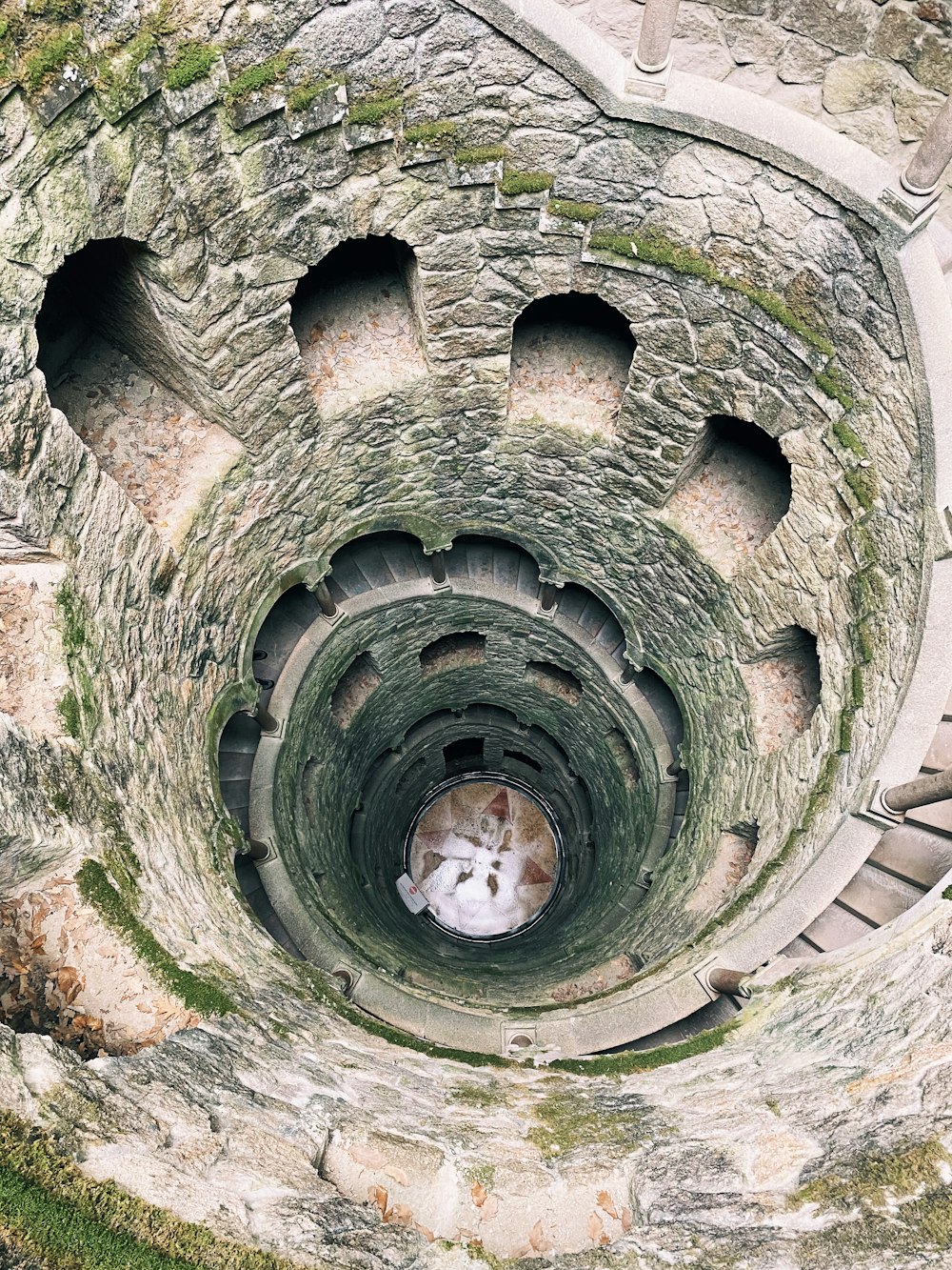 an aerial view of a spiral staircase in a stone building
