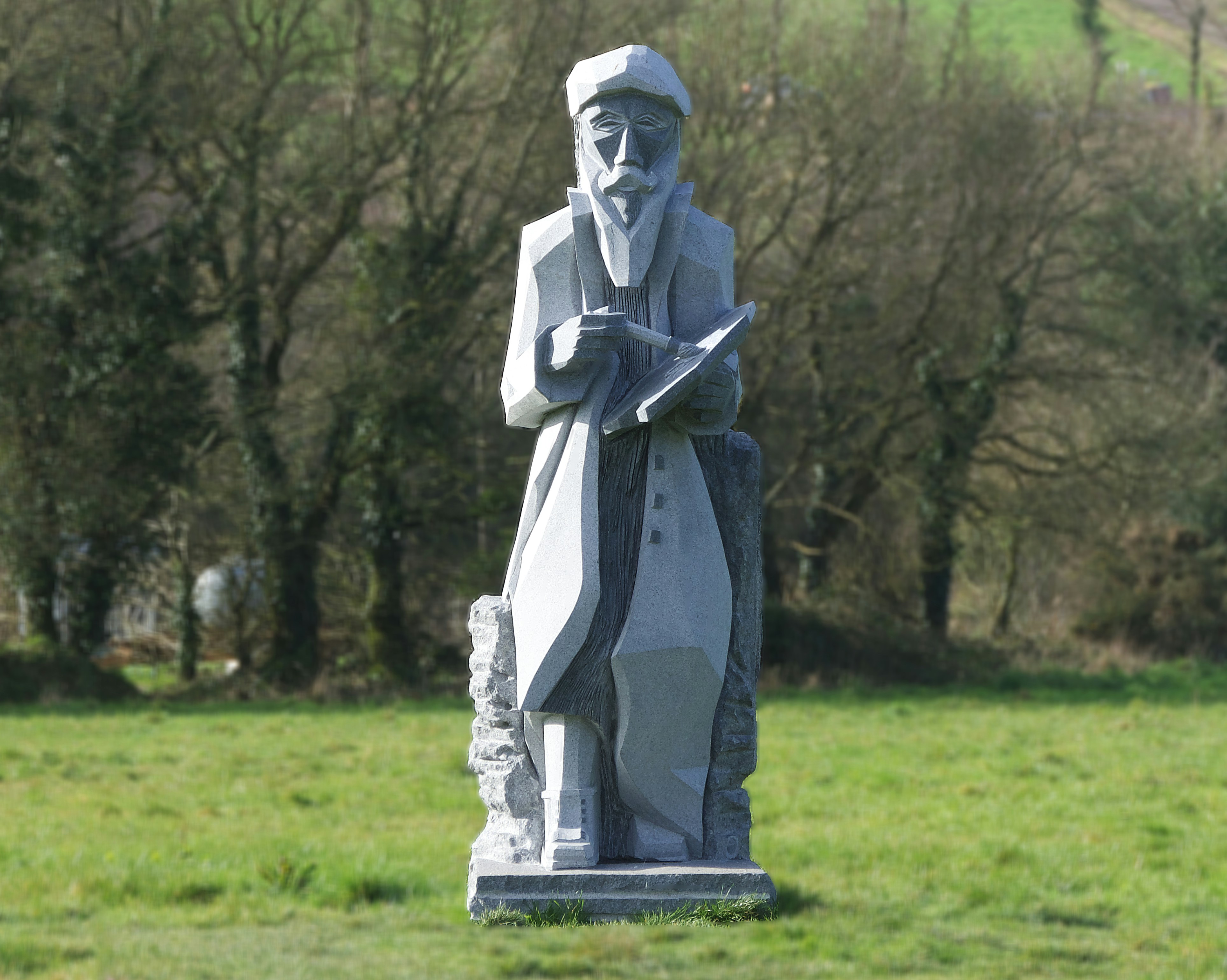 a statue of a man holding a book in a field