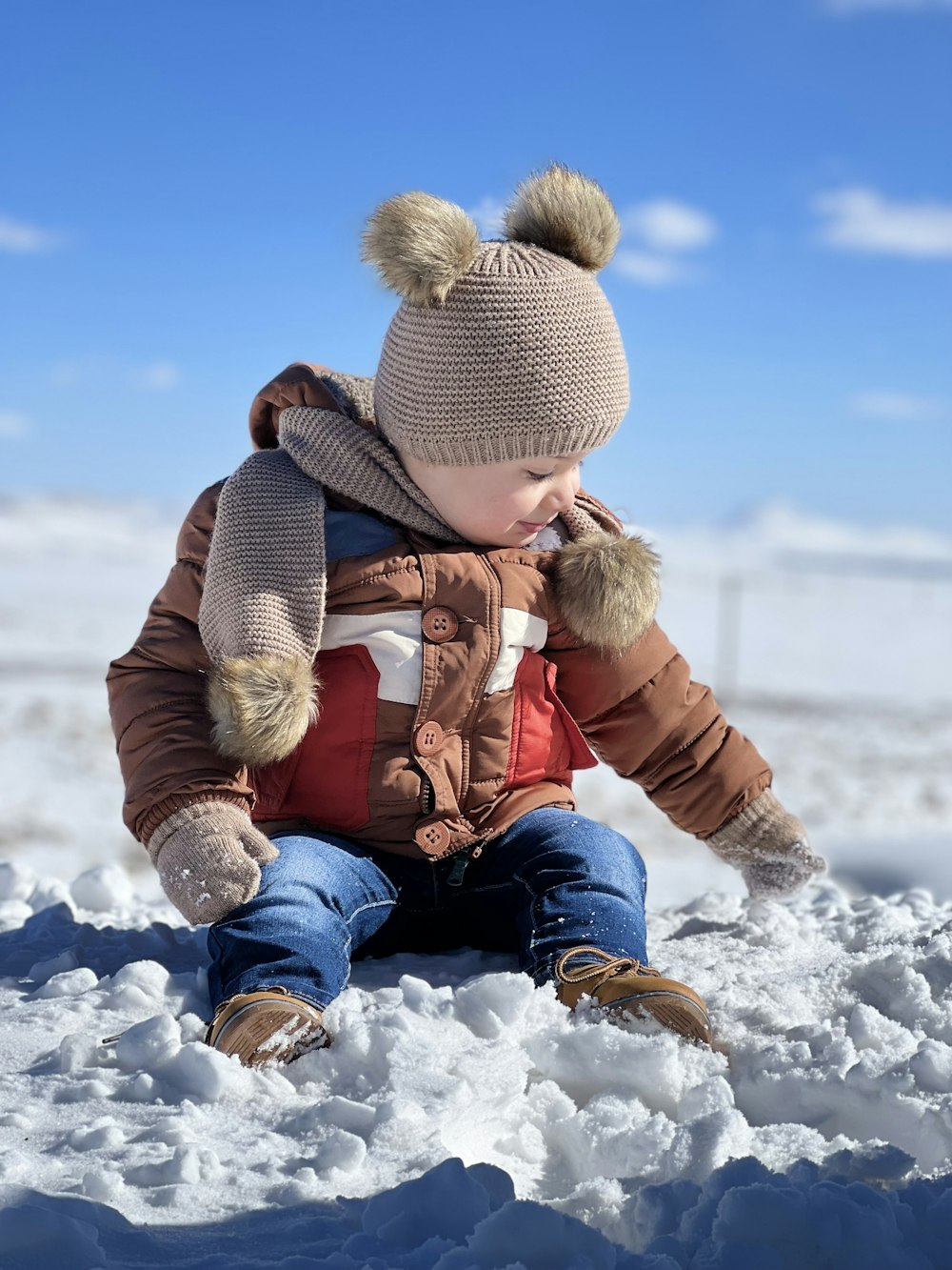 a small child is playing in the snow