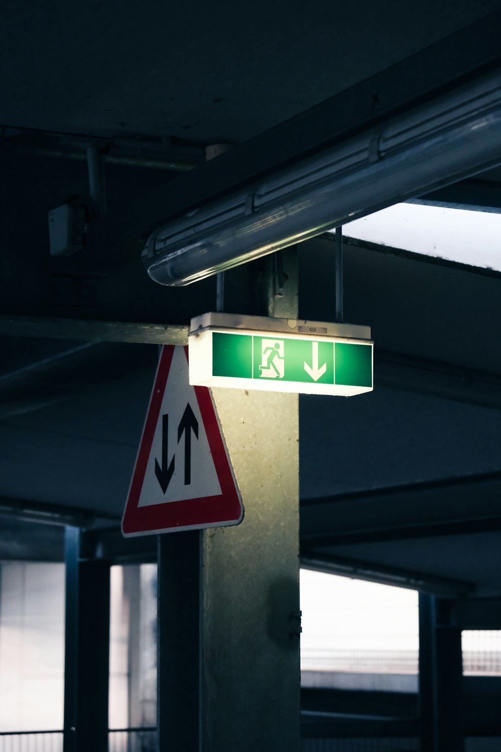 a green and white street sign and a red and white sign