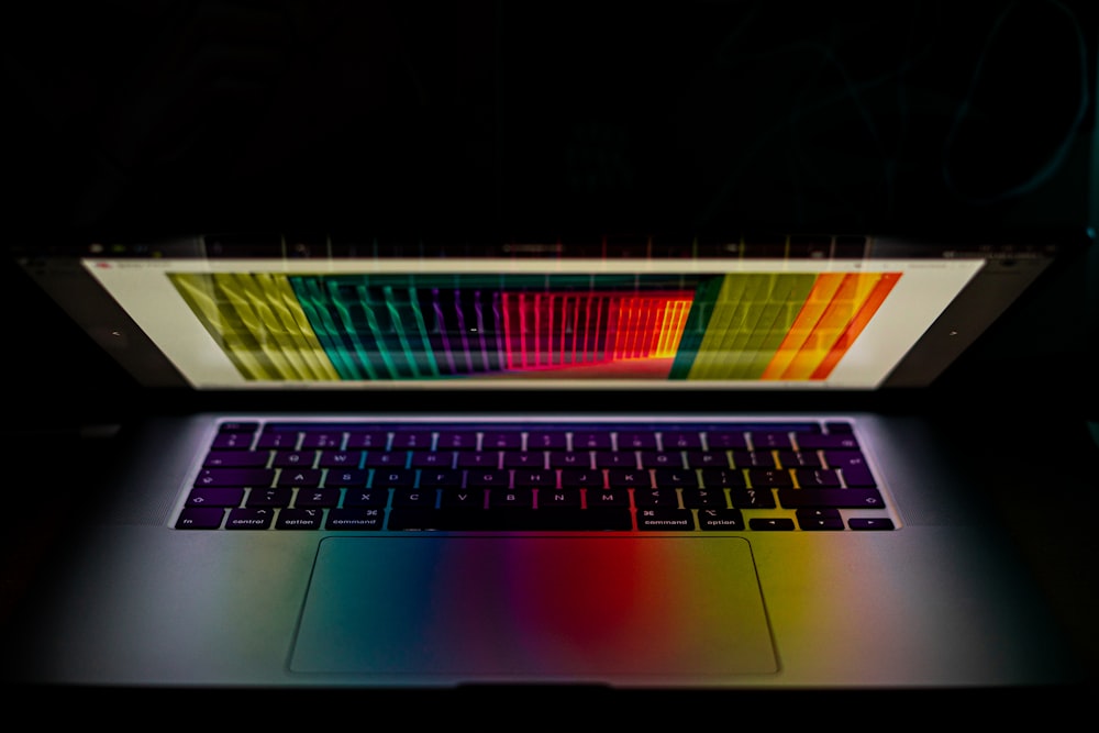 a laptop with a rainbow keyboard lit up