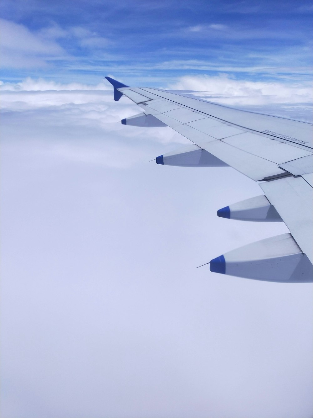 a view of the wing of an airplane in the sky