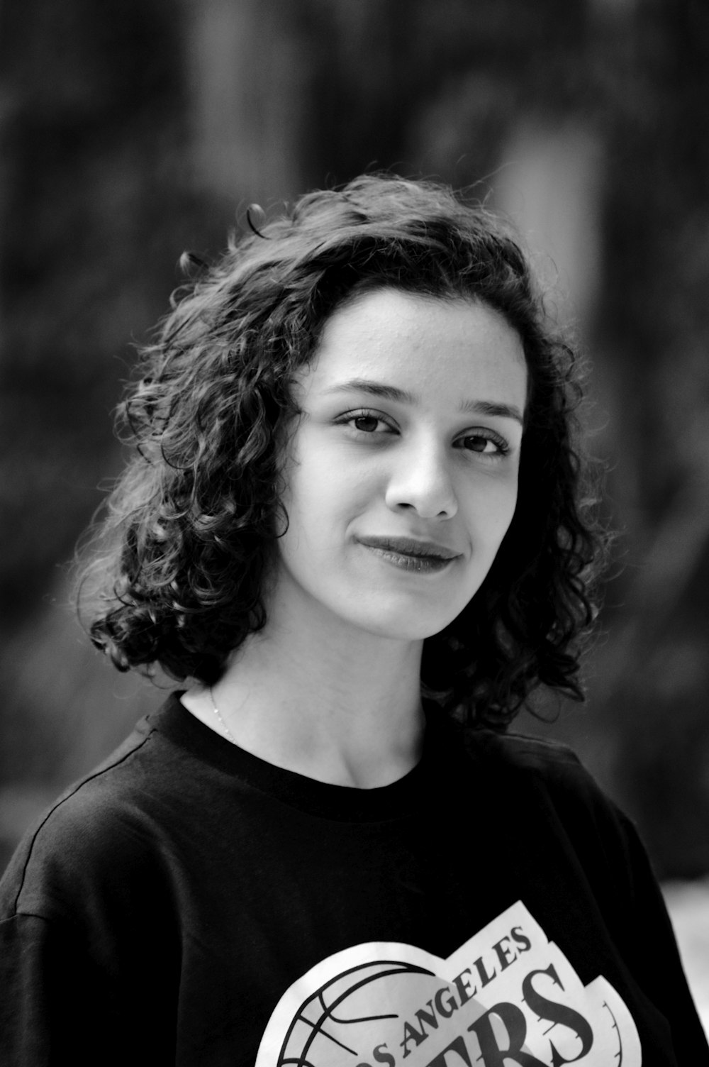 a black and white photo of a woman with curly hair