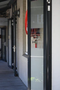 a red fire hydrant sitting on the side of a building