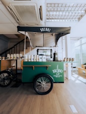 a food cart in a restaurant with a bike parked next to it
