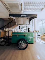 a food cart in a restaurant with a bike parked next to it