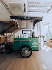 a food cart in a restaurant with a bike parked next to it