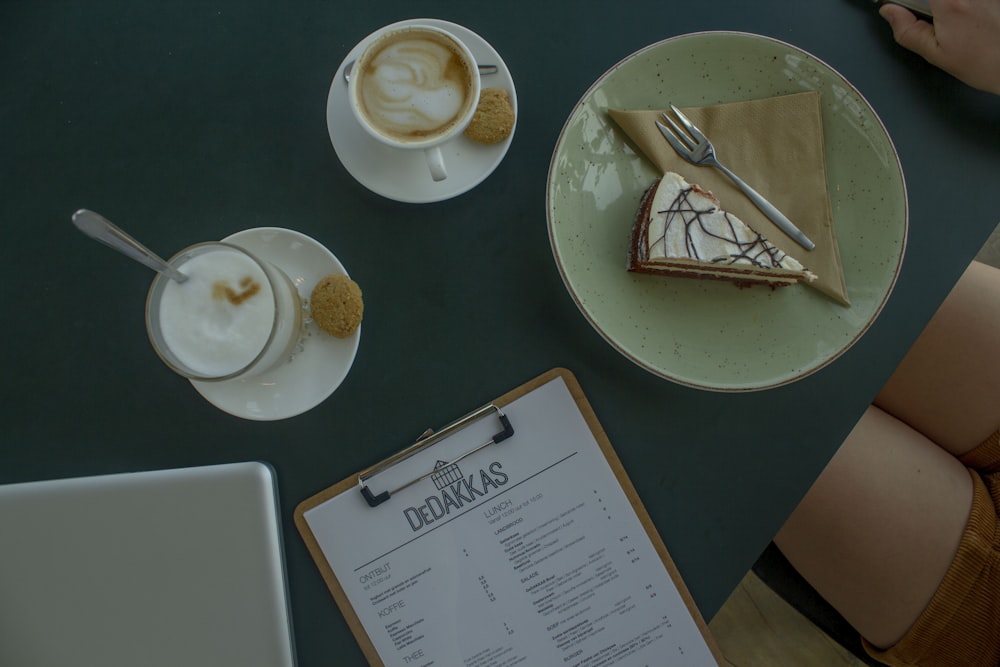 a table topped with plates of food and cups of coffee