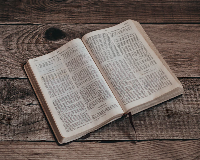 an open book sitting on top of a wooden table