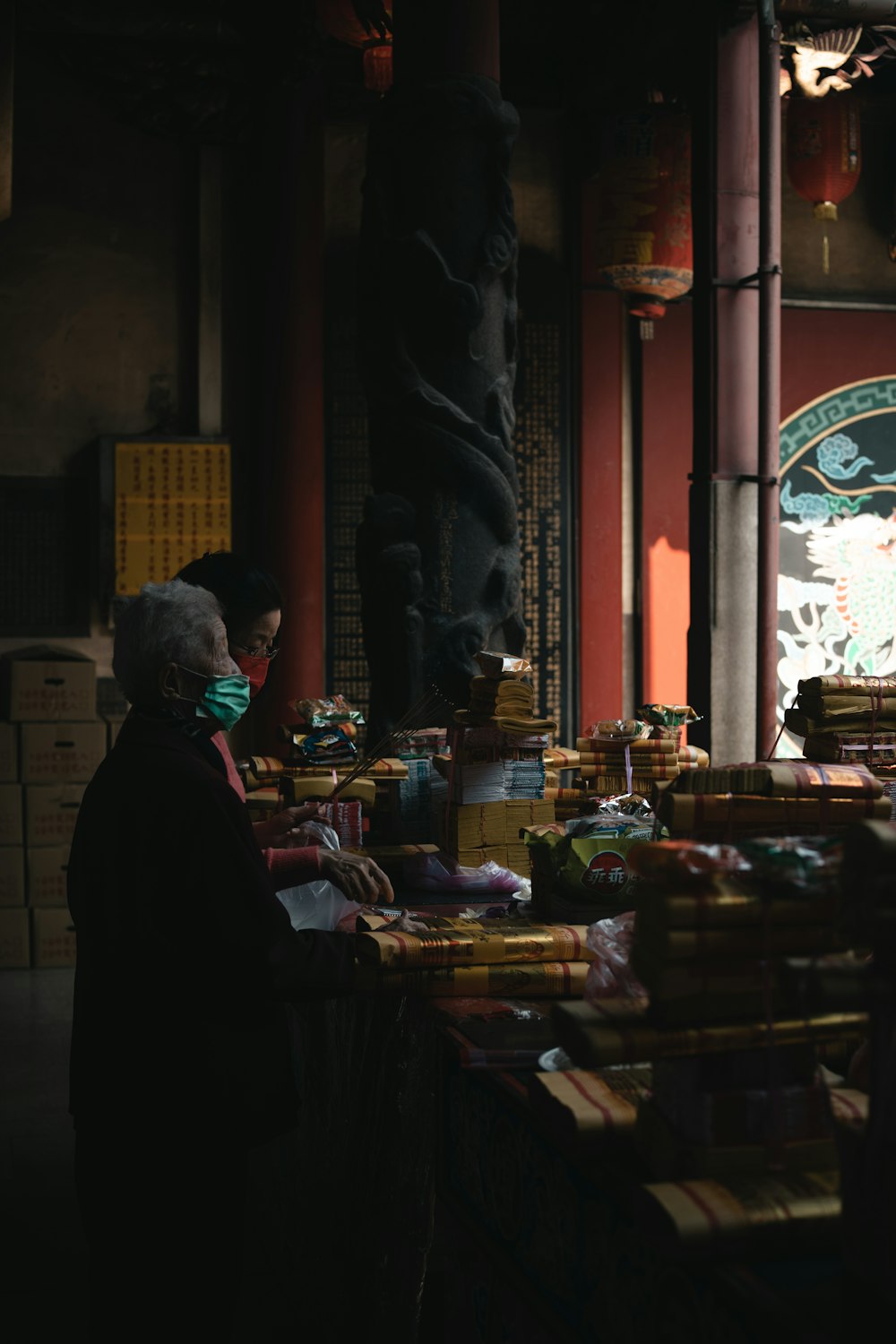 a woman standing in front of a store filled with boxes