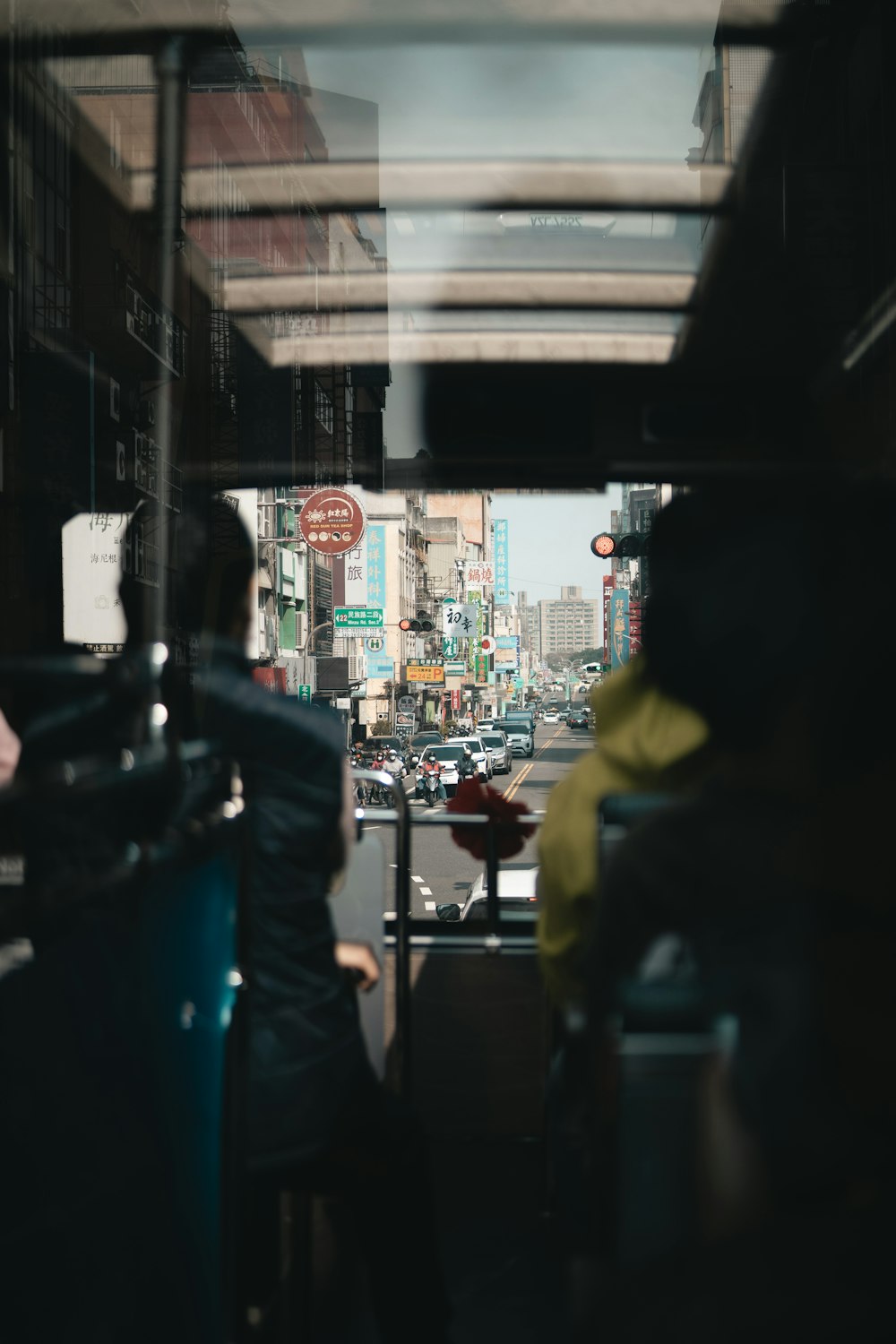 a view of a city street from inside a bus