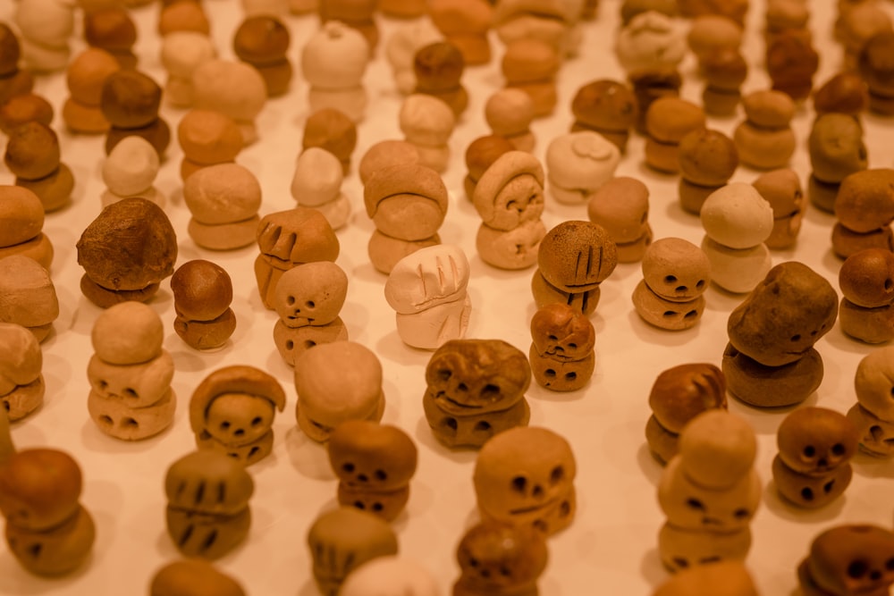 a table topped with lots of small clay heads