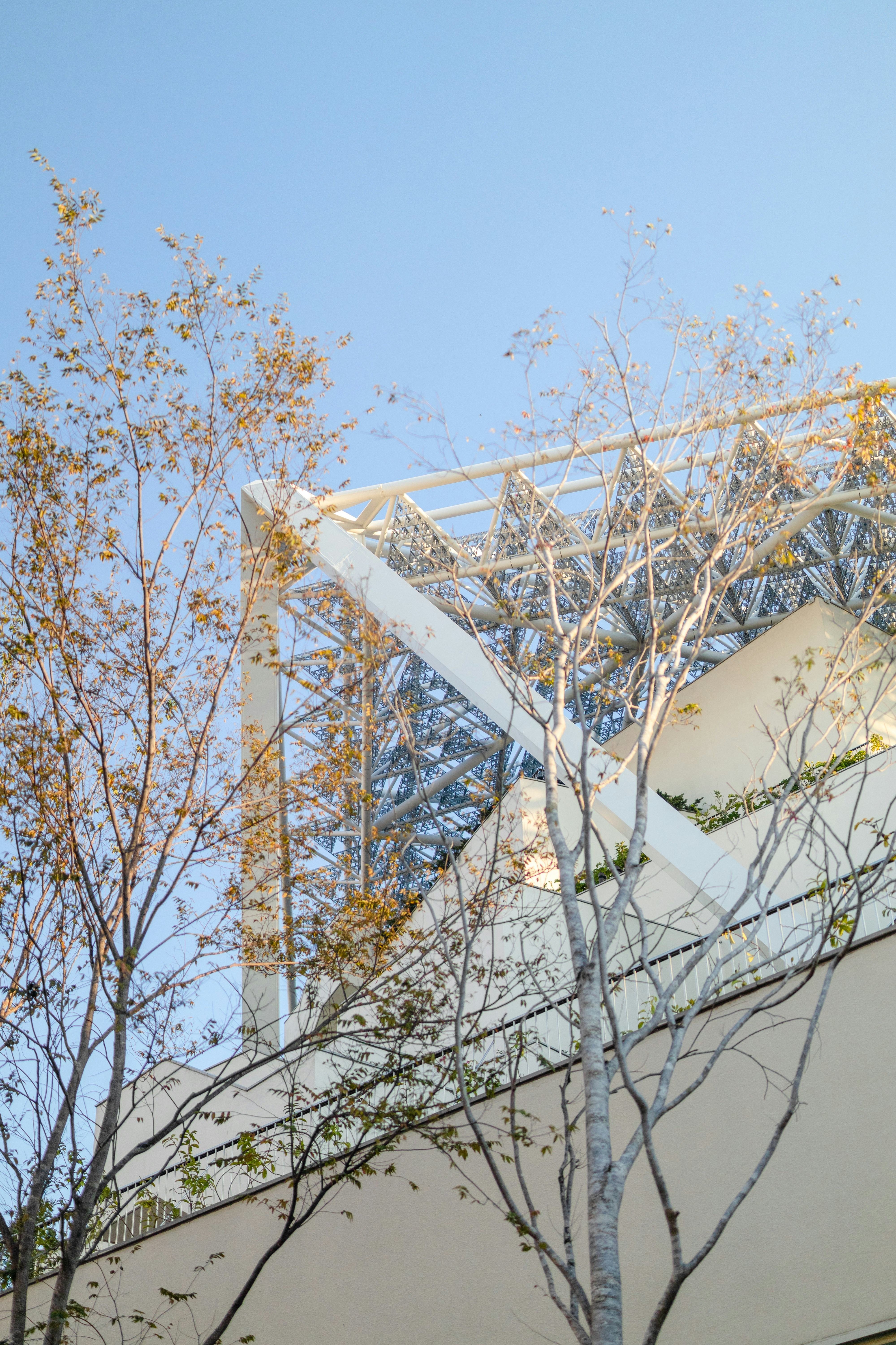 a tall white building with a clock on it's side