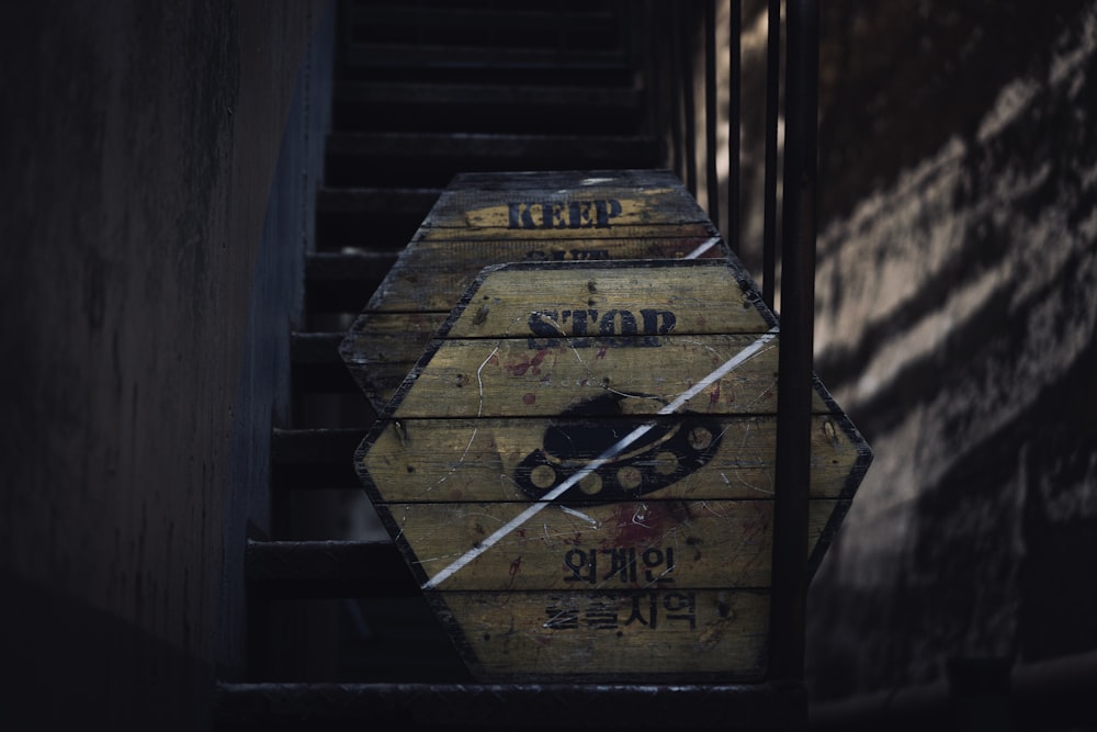 a bunch of wooden signs sitting on top of a set of stairs