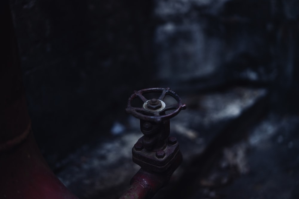 a close up of a pipe with a rusted valve