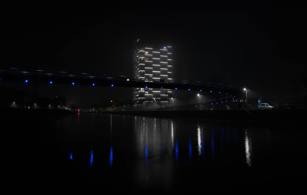 a large bridge over a body of water at night