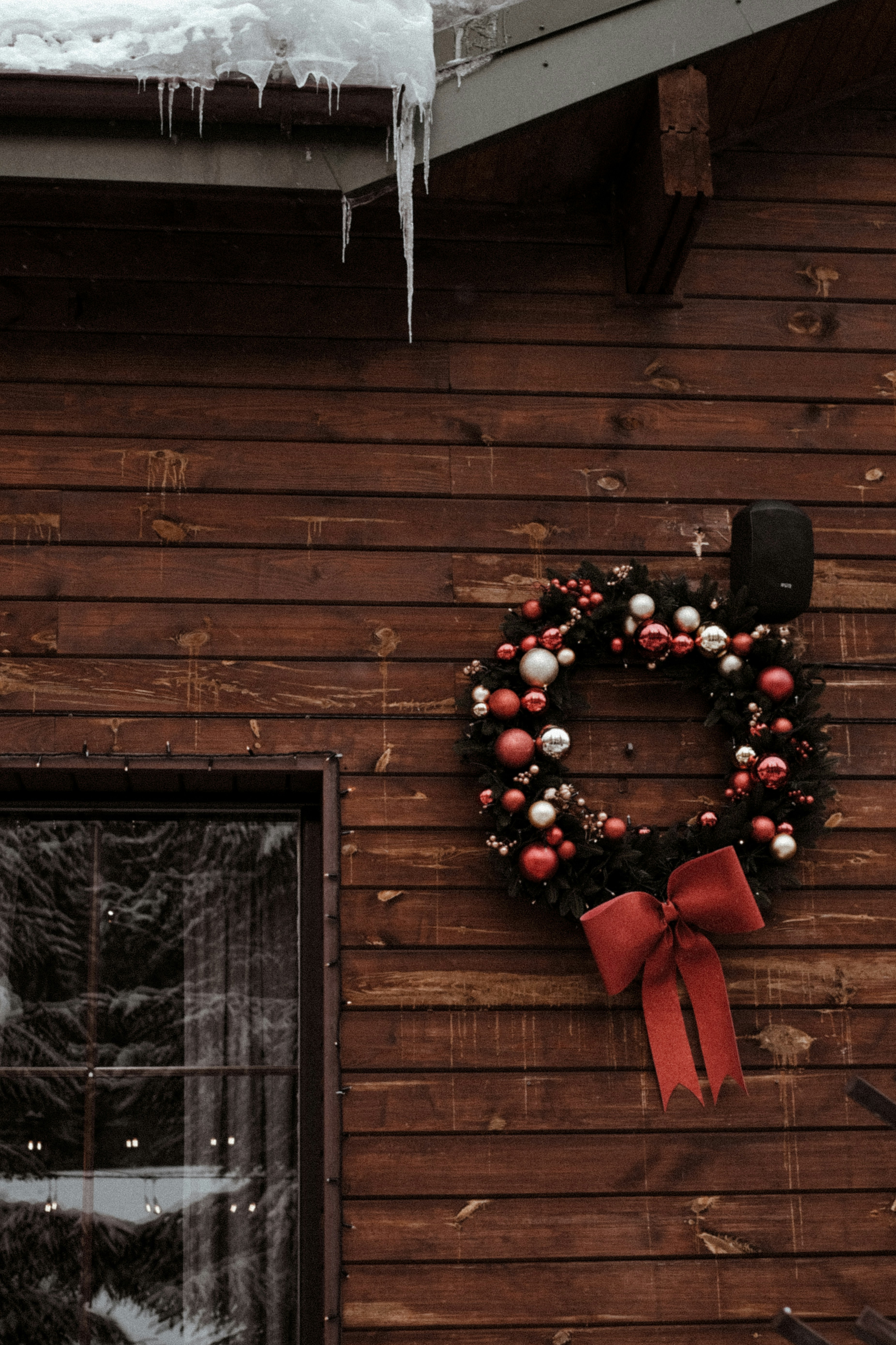 a wreath is hanging on the side of a building