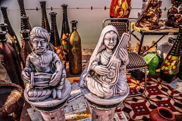 a couple of statues sitting on top of a table