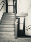 Before and after shot of a restored vintage staircase with detailed woodwork