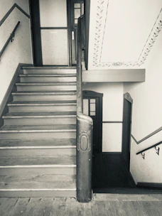 Before and after shots showing a stair remodeling project with upgraded wood and metal finishes.