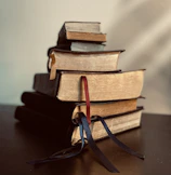 A stack of classic films and books with a warm, retro filter.