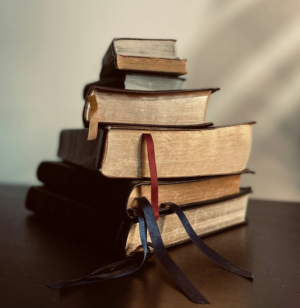 a stack of books sitting on top of a table