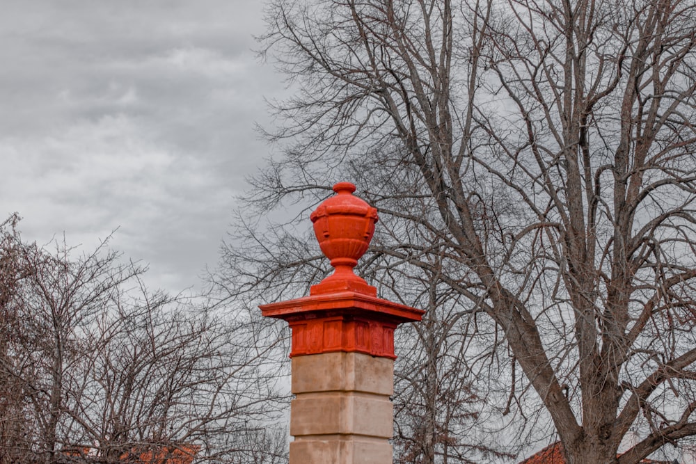 a red fire hydrant sitting next to a tree