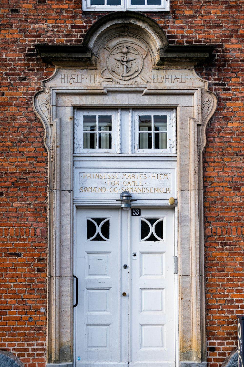 a brick building with a white door and window