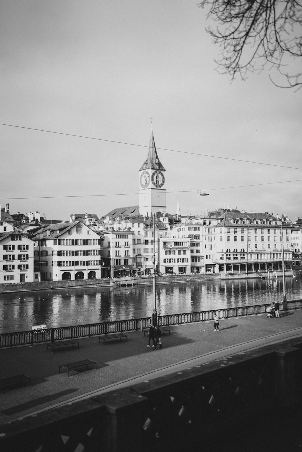 a black and white photo of a city with a clock tower