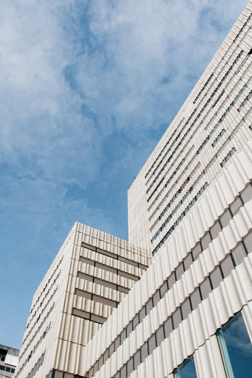 a tall white building with a clock on it's side