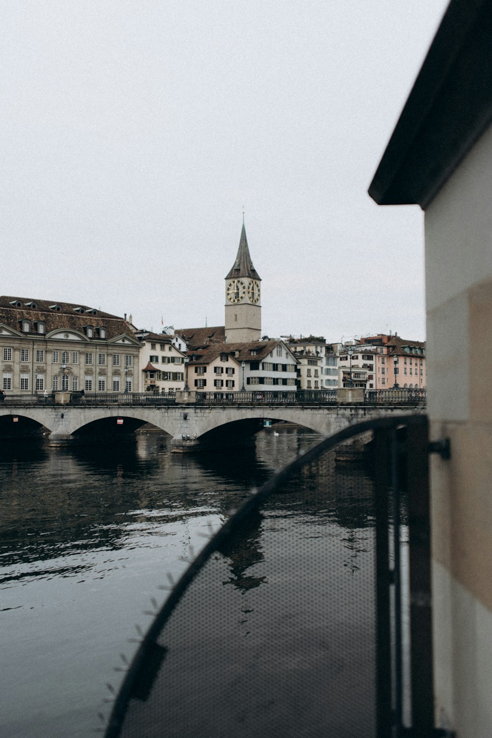 a bridge that has a clock tower in the background