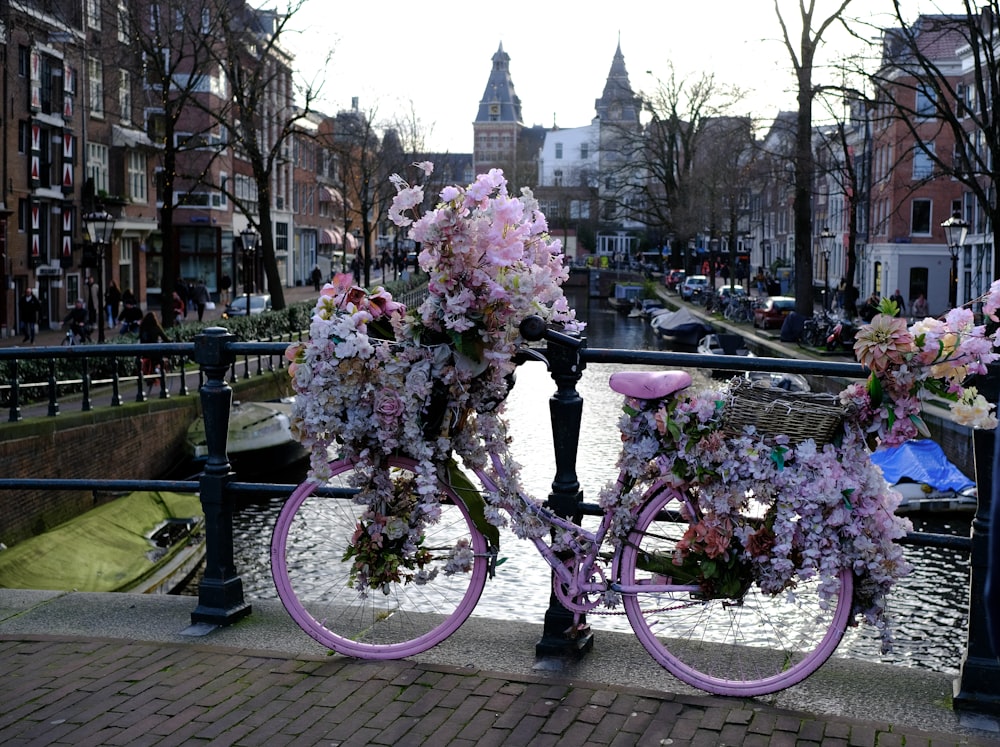 a bicycle decorated with flowers on a bridge