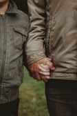 a close up of two people holding hands