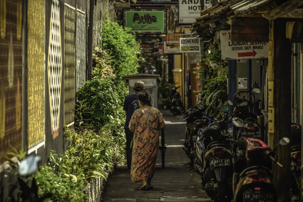 Une femme marchant dans une ruelle étroite