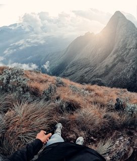 a person laying on top of a grass covered hillside