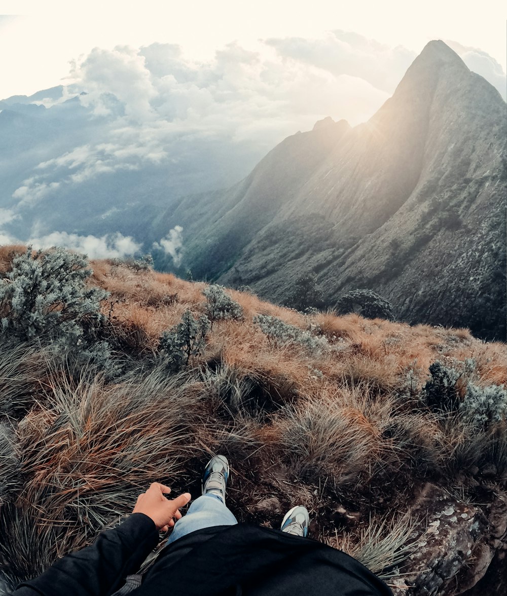 a person laying on top of a grass covered hillside