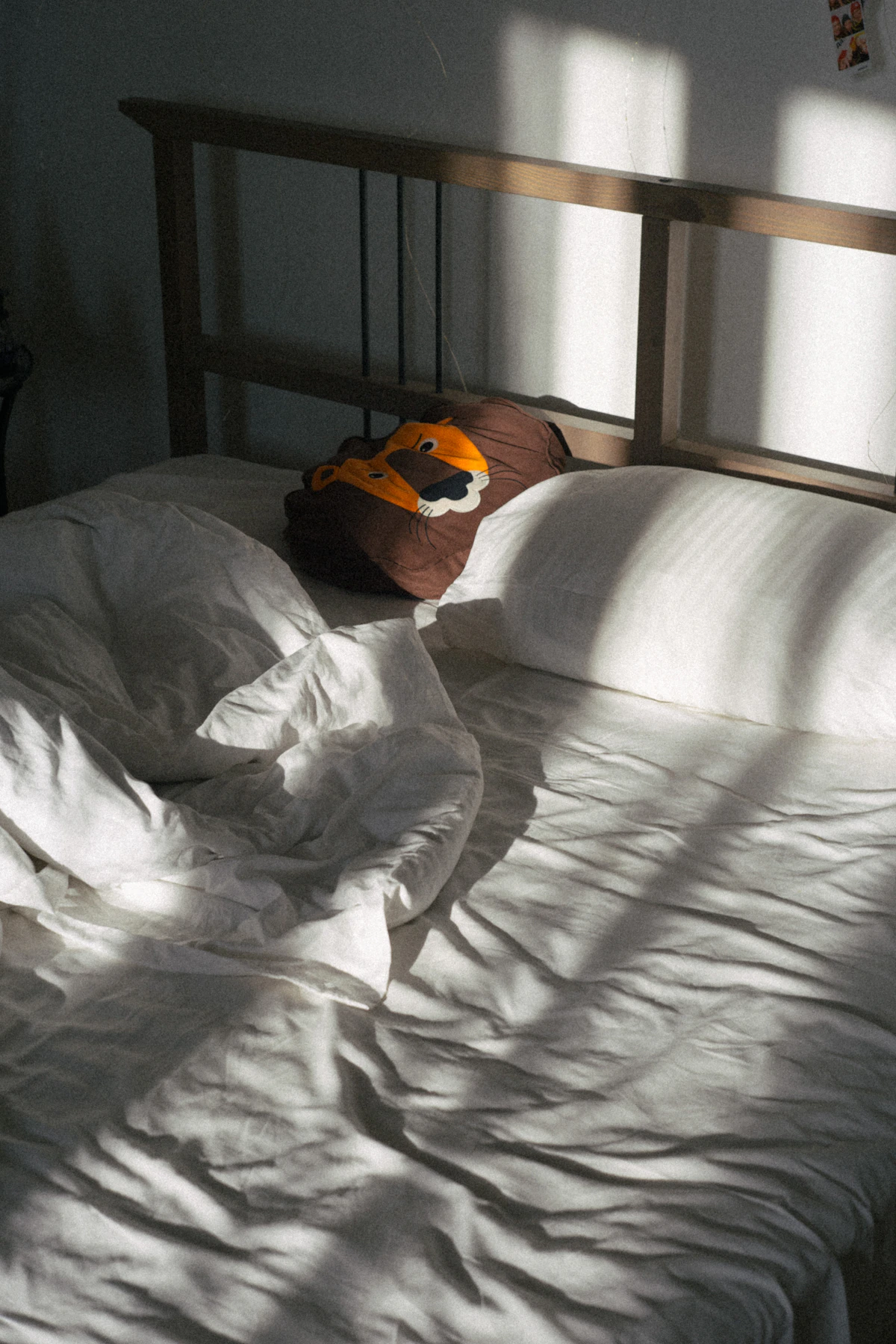 White bed with clean sheets representing a sleep-supporting bedroom environment