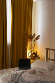 a laptop computer sitting on top of a bed